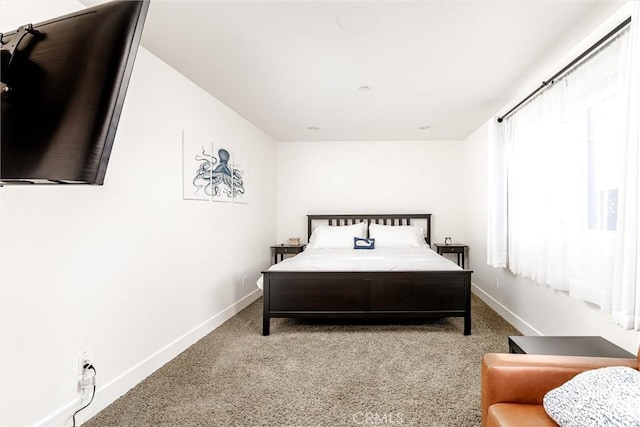 bedroom with light carpet and baseboards