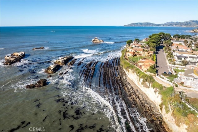 birds eye view of property with a water and mountain view