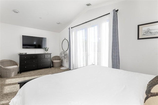 carpeted bedroom with lofted ceiling and visible vents