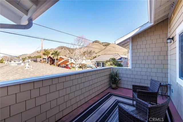 balcony featuring a residential view and a mountain view