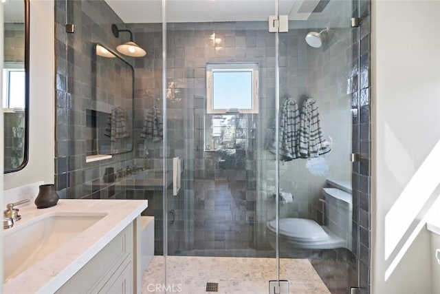 bathroom with a shower stall and vanity