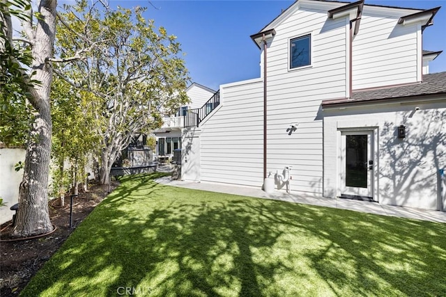 rear view of property featuring a yard