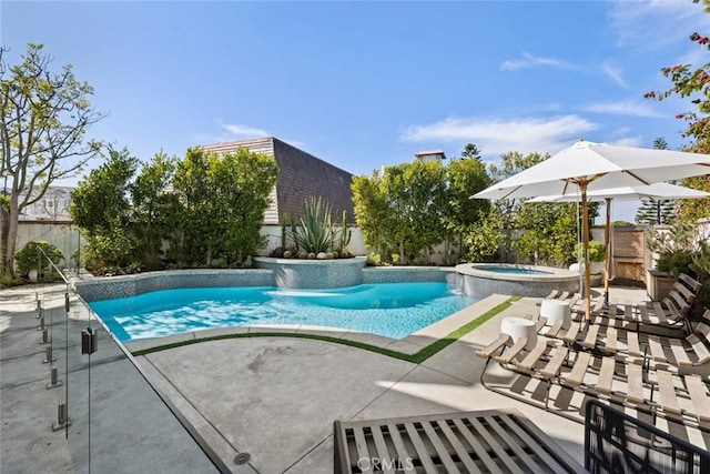 pool featuring a fenced backyard, a patio, and an in ground hot tub