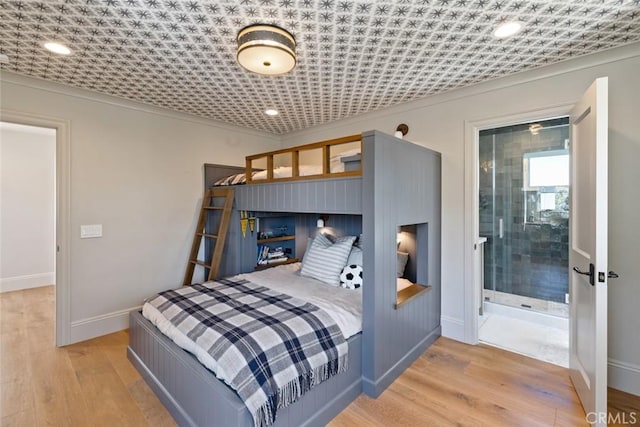 bedroom with baseboards and light wood-style floors