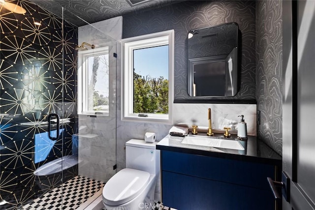 full bath featuring wallpapered walls, a shower stall, toilet, and vanity