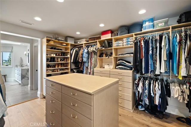 walk in closet with light wood-type flooring and visible vents