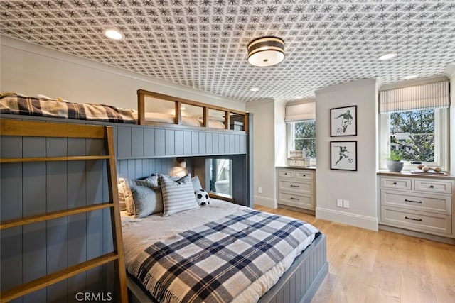 bedroom with baseboards and light wood finished floors