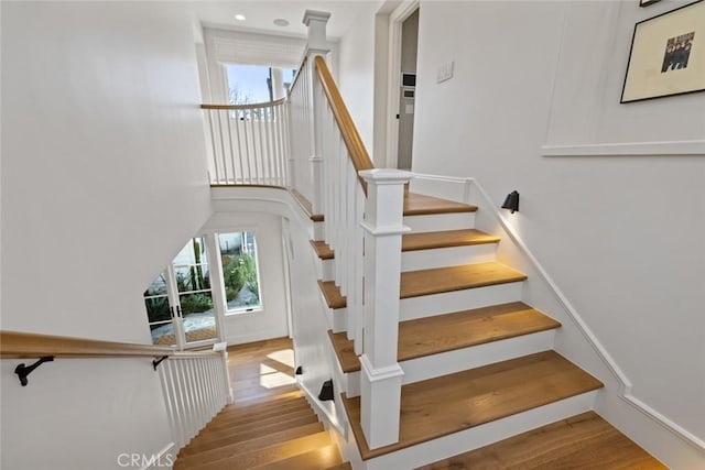 stairway with baseboards and wood finished floors