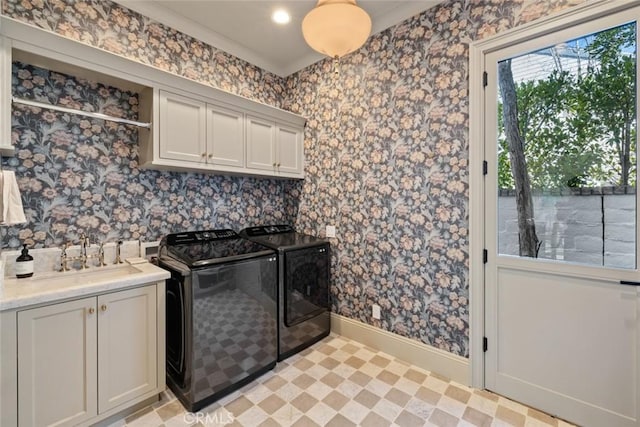 kitchen featuring light countertops, independent washer and dryer, a sink, and wallpapered walls