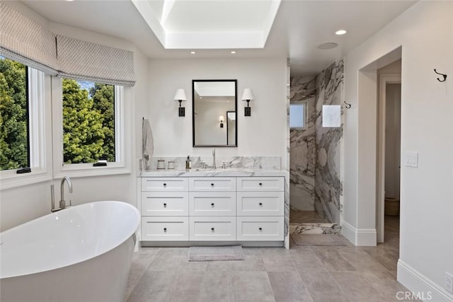 bathroom with a marble finish shower, recessed lighting, a freestanding bath, vanity, and baseboards