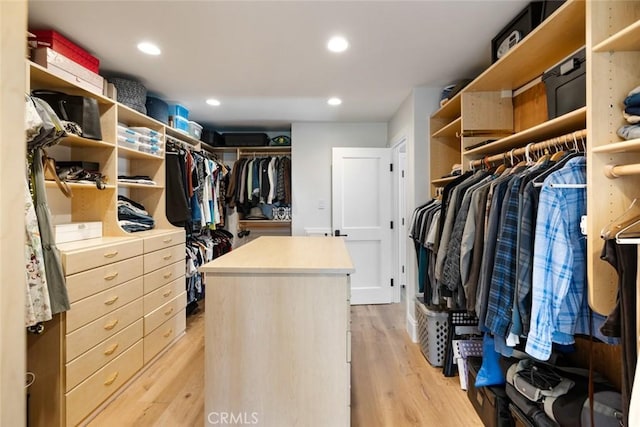 walk in closet with light wood-style flooring