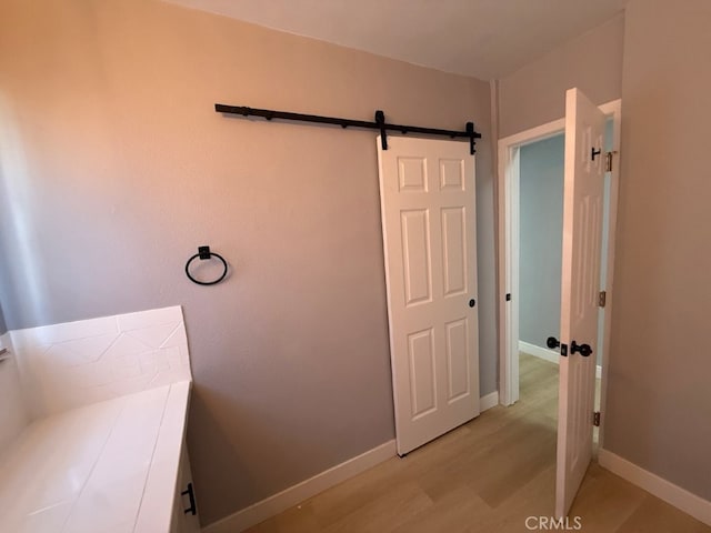 bathroom featuring wood finished floors and baseboards