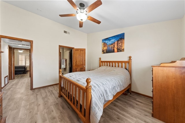 bedroom featuring a ceiling fan, baseboards, visible vents, and wood finished floors