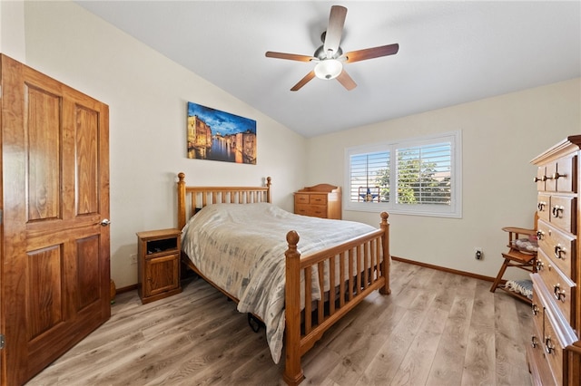 bedroom with lofted ceiling, light wood-style flooring, baseboards, and ceiling fan