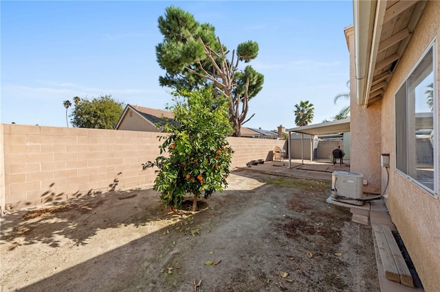 view of yard featuring ac unit, a fenced backyard, and a patio