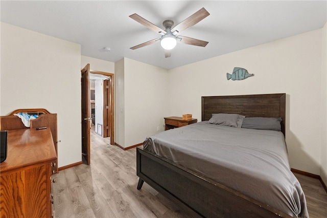 bedroom featuring ceiling fan, light wood-style flooring, and baseboards