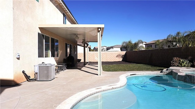 view of pool featuring central AC unit, a patio, a fenced backyard, ceiling fan, and a pool with connected hot tub