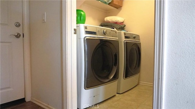 laundry room featuring laundry area, washer and clothes dryer, and baseboards