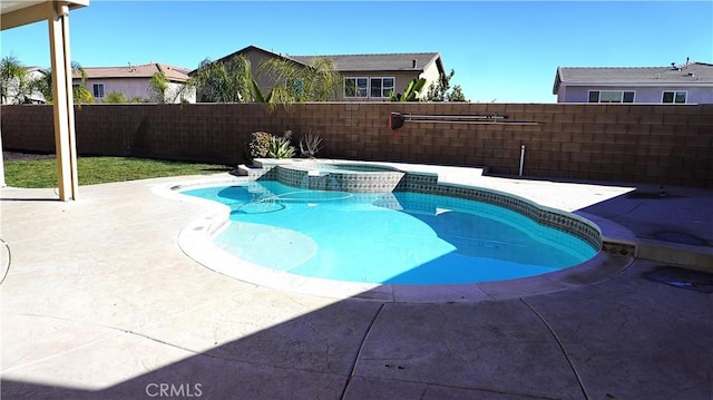 view of swimming pool with a pool with connected hot tub, a fenced backyard, and a patio