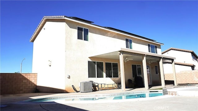 rear view of house featuring a ceiling fan, a patio area, fence, and stucco siding