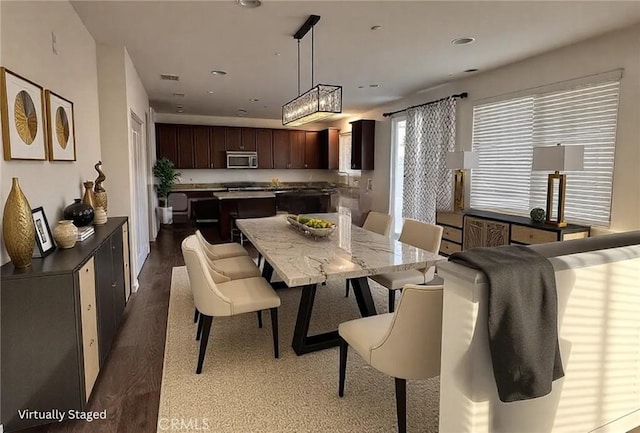 dining space featuring dark wood-style flooring