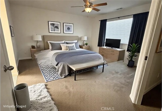 bedroom with a ceiling fan, light colored carpet, and baseboards