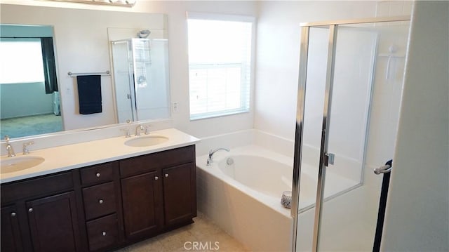 bathroom featuring a sink, a bath, and a shower stall