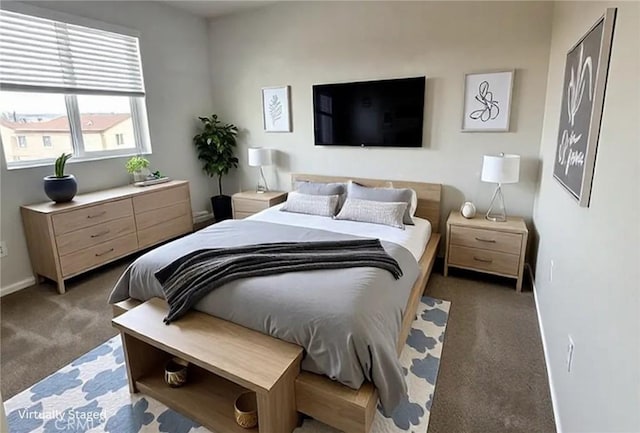 bedroom featuring dark carpet and baseboards