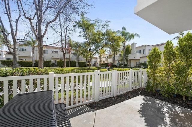 view of patio / terrace with a residential view and fence