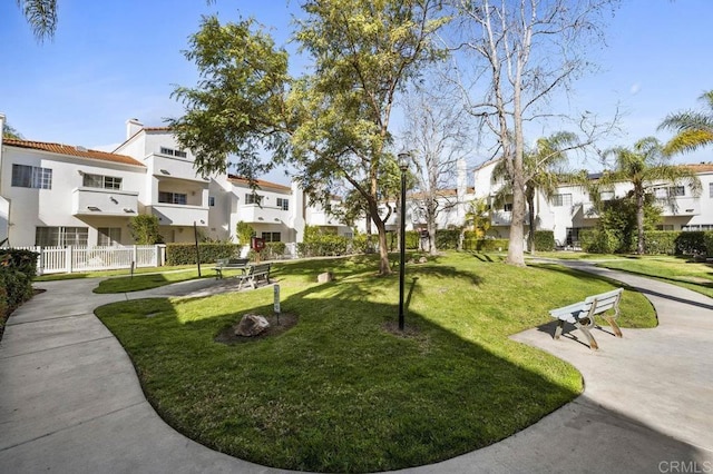 view of home's community featuring a residential view and a yard