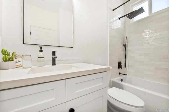 bathroom with toilet, vanity, and bathing tub / shower combination