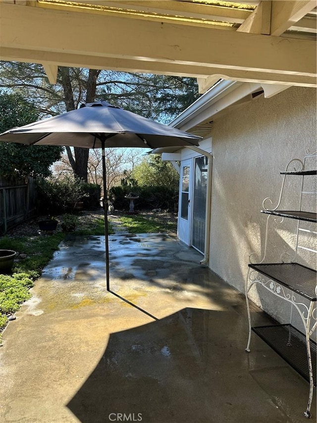 view of patio / terrace featuring fence