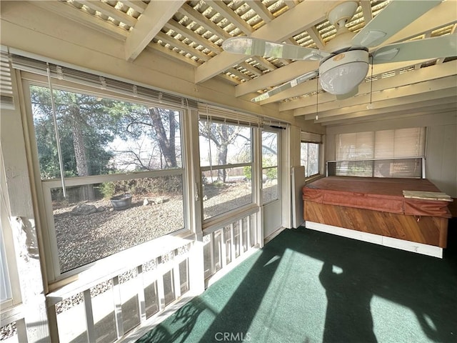 sunroom featuring beam ceiling