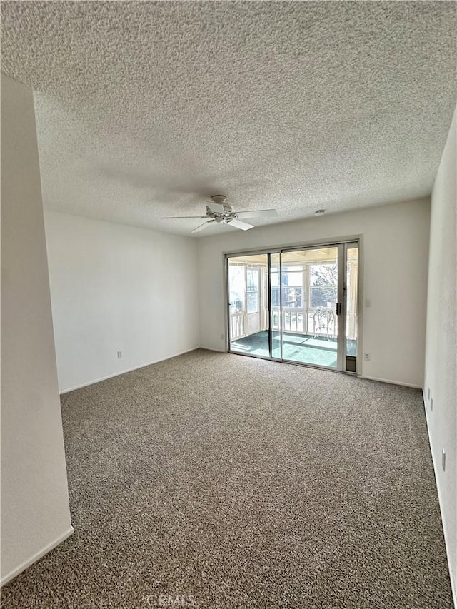 spare room featuring ceiling fan, a textured ceiling, and carpet