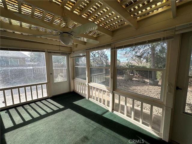 unfurnished sunroom featuring a ceiling fan