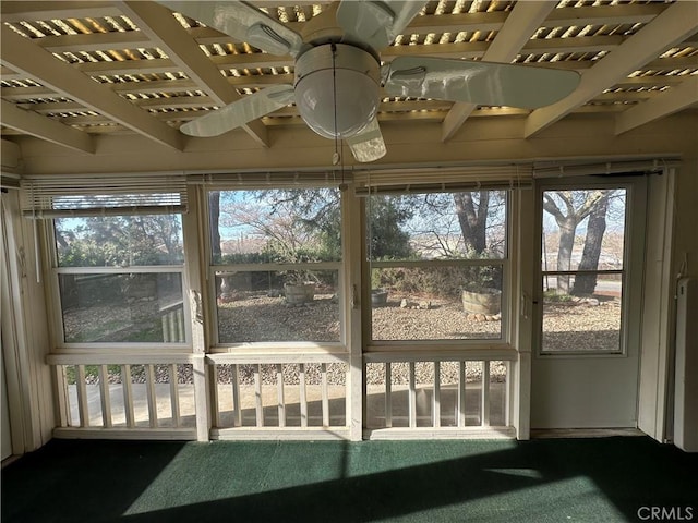 sunroom / solarium featuring a ceiling fan