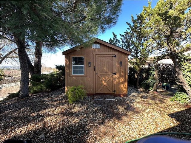 view of shed with fence