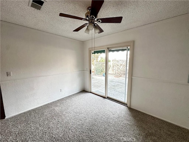 carpeted empty room featuring baseboards, visible vents, a textured wall, ceiling fan, and a textured ceiling