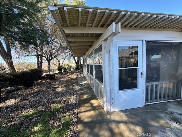 view of side of property with a sunroom, a standing seam roof, and metal roof