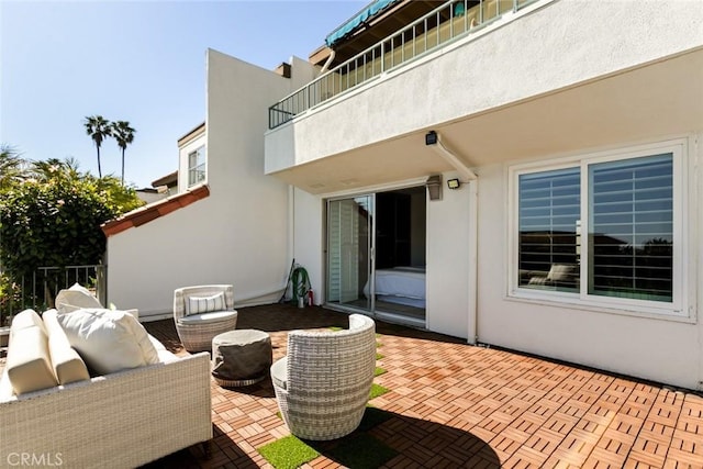 view of patio featuring an outdoor living space and a balcony