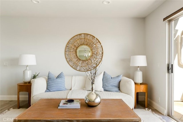 living area featuring light wood-style floors, baseboards, and recessed lighting