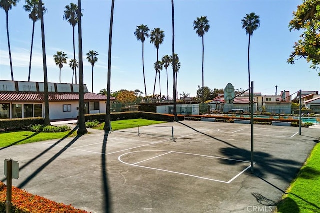 view of basketball court with a tennis court, community basketball court, and fence