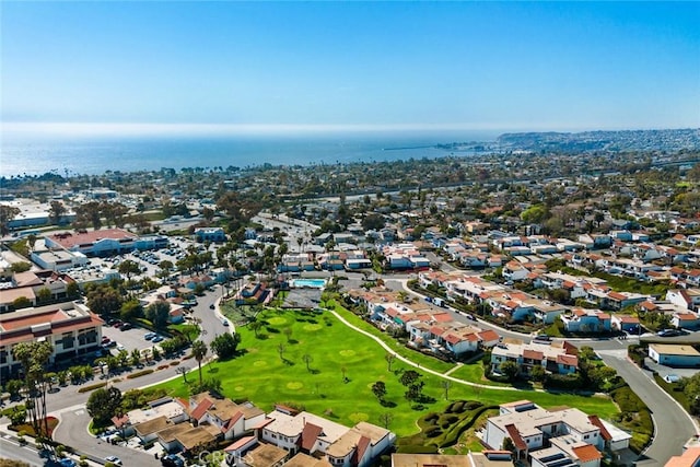 birds eye view of property with view of golf course and a water view