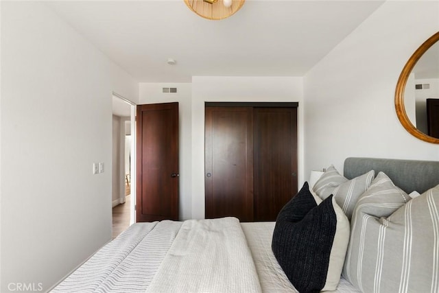 bedroom featuring a closet and visible vents