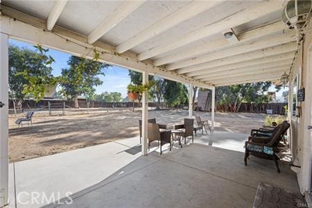 view of patio / terrace featuring fence