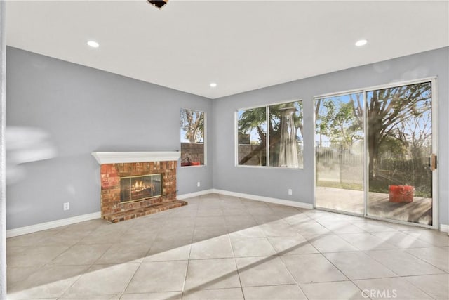 unfurnished living room with recessed lighting, a fireplace, baseboards, and light tile patterned flooring