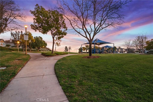 view of community featuring playground community and a yard