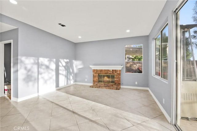 unfurnished living room with light tile patterned floors, a fireplace, baseboards, and recessed lighting