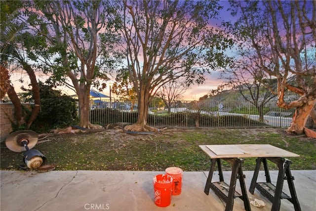 view of home's community with a yard, a patio area, and fence