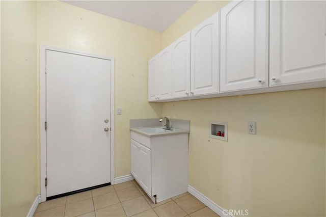 laundry room with light tile patterned floors, hookup for a washing machine, a sink, baseboards, and cabinet space